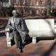 Statue of William Peace sitting on a bench on the college campus named after him.